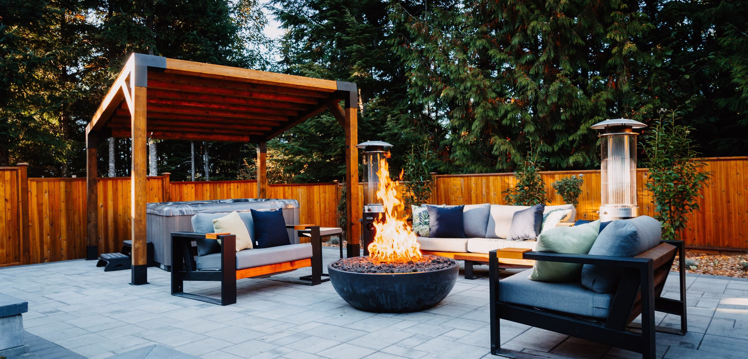 Zen 48 gas fire pit in a backyard with louge furniture and pergola